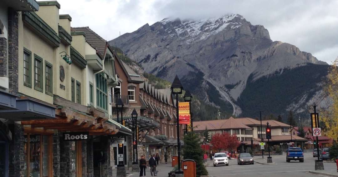 Stores along the street with mountain behind them